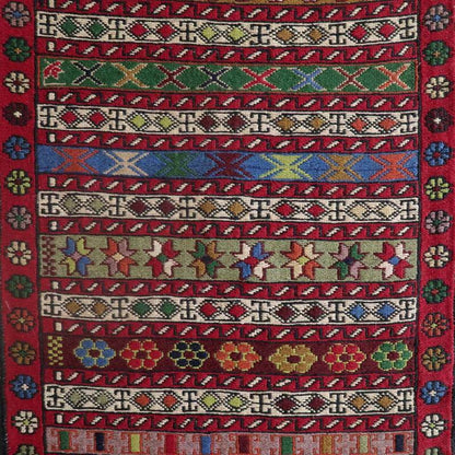 Handwoven Kilim rug from Azerbaijan with intricate Smack weaving technique, vibrant multicolor geometric patterns on red wool, 105x51cm.